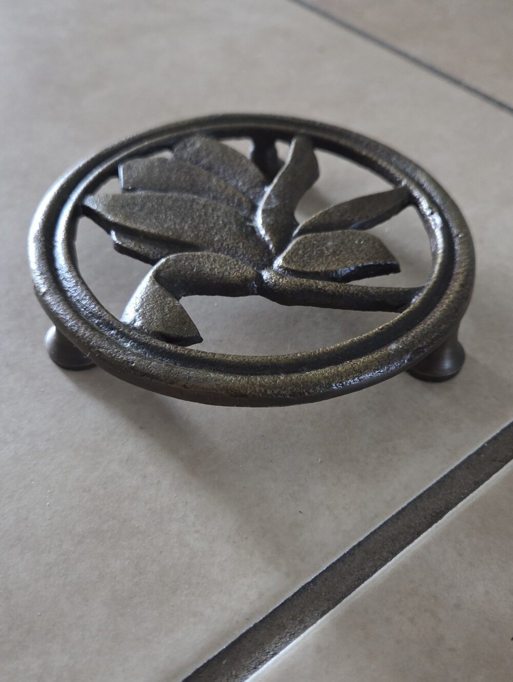 Magnolia Antique Brass Trivet in a floral design